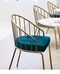 four chairs with blue cushions sit in a room next to each other on the floor