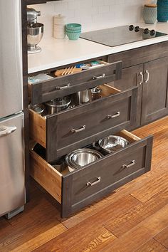 an open drawer in the middle of a kitchen