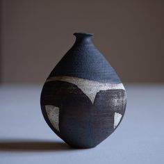 a black and white vase sitting on top of a table