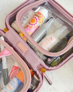 the contents of a pink travel bag are neatly packed