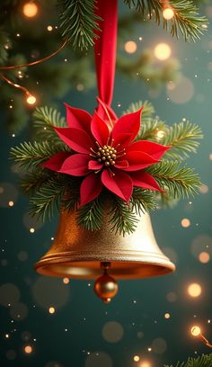 a golden bell with a red flower on it