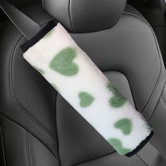 a car seat cushion with green spots on it's arm and headrests