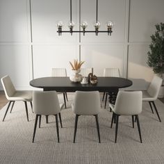 a black table with white chairs and a potted plant on it in front of a paneled wall