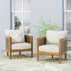 two chairs sitting next to each other on top of a rug