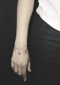 a woman's left arm with a small star tattoo on the right side of her wrist