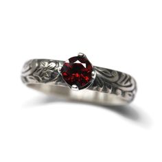 Red Garnet Ring This handmade ring features a 5mm AA Grade Red Garnet faceted stone, prong mounted on a 4mm wide 925 Sterling Silver Flower and Vine pattern band. Oxidized to a Vintage Silver finish. Ring sizer included. Shipped in gift box. Red Garnet is the birthstone for January. | 5Mm Aa Grade Red Garnet Ring Flower Vine Pattern Vintage Silver By Salish Sea Inspirations Red Garnet Ring, Red Jewel, Flowering Vines, Sterling Silver Flowers, Garnet Rings, Red Garnet, Silver Band, Vintage Patterns, Vintage Silver