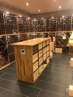 a wine cellar filled with lots of bottles and wooden boxes on the floor next to each other