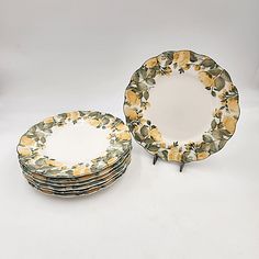 a stack of yellow and green plates sitting on top of each other