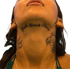 a woman with tattoos on her neck and chest