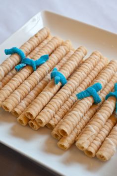 several pieces of food on a plate with blue icing in the shape of birds