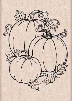 a rubber stamp with three pumpkins and leaves