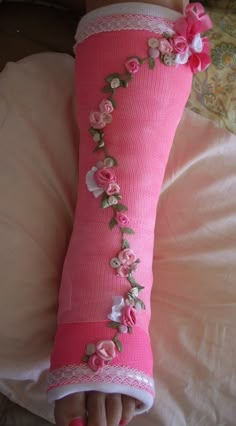 a pink pillow with flowers and lace on it