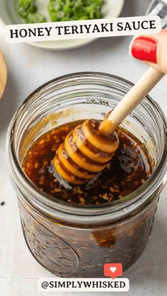 a jar filled with honey sitting on top of a table