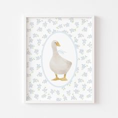 a white duck in a blue frame on a wall