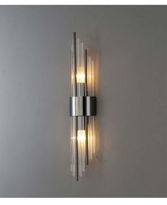 a modern wall light with three lights on the side and two bulbs in the middle