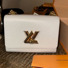 Brand New Twist Mm Louis Vuitton In Grey. 9.1 X 6.7 X 3.7. Eli Grained Leather, Gold Hardware, Lv Twist Lock White Luis Viton Bag, Black And White Louis Vuitton Bag, White Louis Vuitton Handbag, White Louis Vuitton Bag, Lv Twist, Louis Vuitton Gifts, Dream Bags, Louis Vuitton Twist, Louis Vuitton Twist Bag