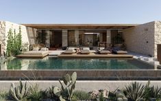 an outdoor living area with couches, tables and cacti in the foreground