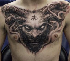 a man with tattoos on his chest has an image of a demon and the cross