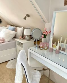 a bedroom with a bed, desk and mirror