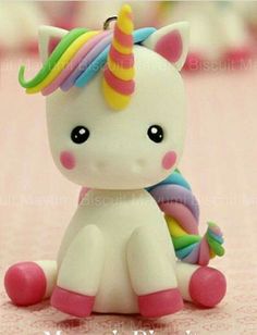 a small toy unicorn sitting on top of a table