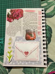 an open notebook with paper and flowers on it