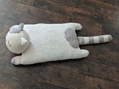 a stuffed animal laying on top of a wooden floor