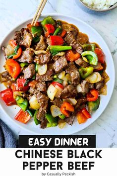 an easy dinner with beef, vegetables and rice on a white plate next to chopsticks