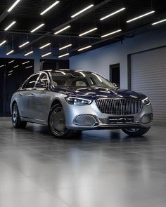 a silver car is parked in an empty garage