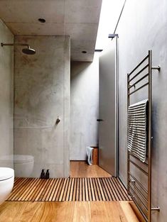 a bathroom with wooden flooring and white walls