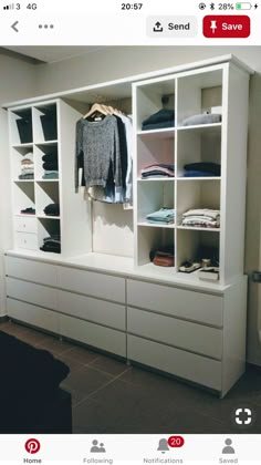 a white closet with clothes and shoes on it's shelves, next to a couch