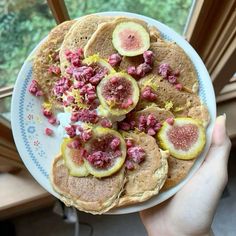 a white plate topped with pancakes covered in fruit