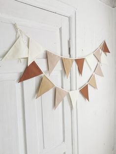 a white door with some brown and tan pennants hanging from it