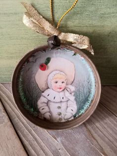 a glass ornament with an image of a child