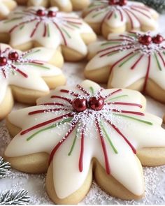 decorated cookies are arranged on a platter with snow flakes and candy canes