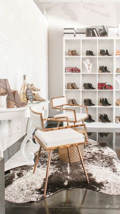 a living room filled with lots of white furniture and shelves full of different types of shoes