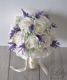 a bridal bouquet with white roses and lavenders