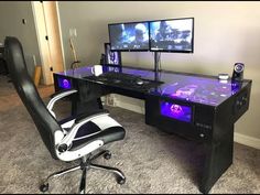 a computer desk with two monitors and a keyboard on it in front of a wall