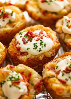 some food that is sitting on top of a metal rack with white sauce and green sprinkles