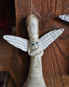 a white angel figurine with blue flowers on it