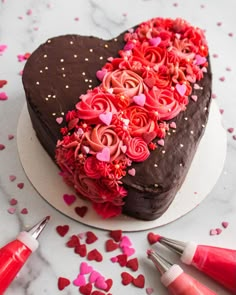 a heart shaped chocolate cake with pink and red icing