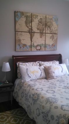 a bedroom with a bed, nightstand and two paintings on the wall above it's headboard