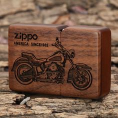 a wooden box with an image of a motorcycle on the front and side, sitting on some rocks