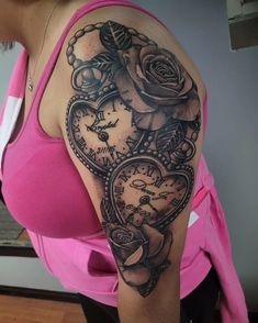 a woman's arm with a clock and roses tattoo on the back of her shoulder