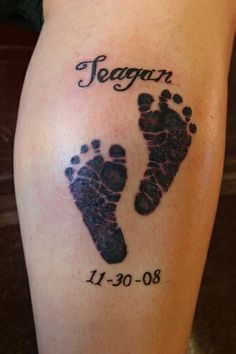 an image of a tattoo on someone's leg with the name and baby footprints