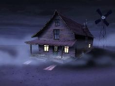 a house with a windmill in the background and fog on the ground around it at night