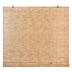 a bamboo wall hanging on the side of a white wall