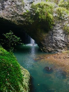 there is a small waterfall coming out of the cave