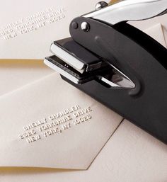 several envelopes with some type of stapler on top of one that has writing on it