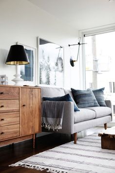 a living room filled with furniture and a large window