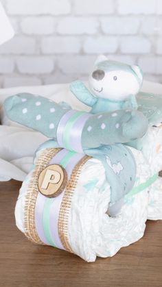 a teddy bear sitting on top of a diaper